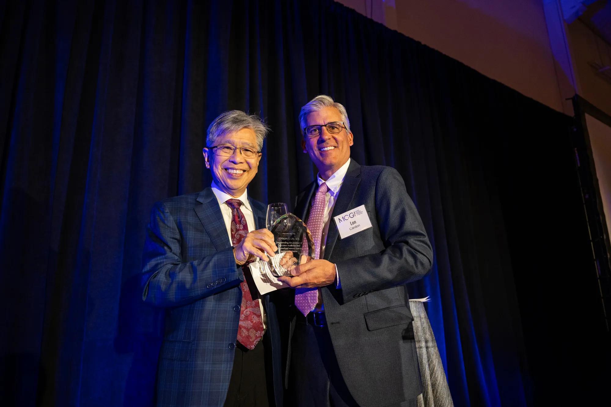 JAX President and CEO Lon Cardon (right) presents an award to JAX President Emeritus Edison T. Liu for his role in shaping MCGI. Credit: Luke Madden, The Jackson Laboratory.